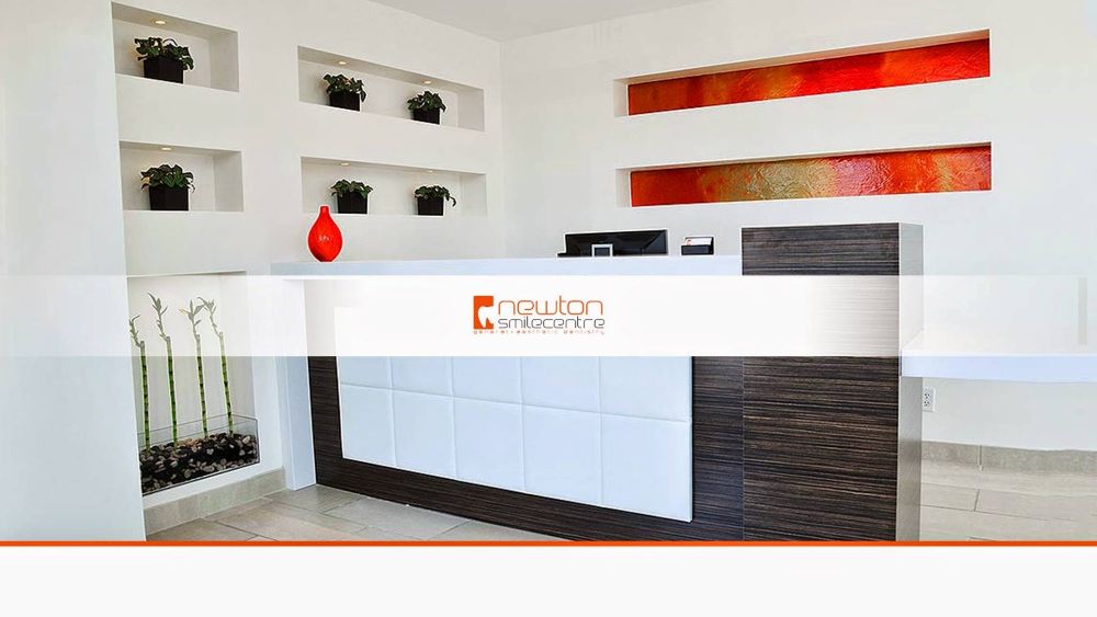 Newton Smile Centre reception area with logo, modern white desk, and decorative accents